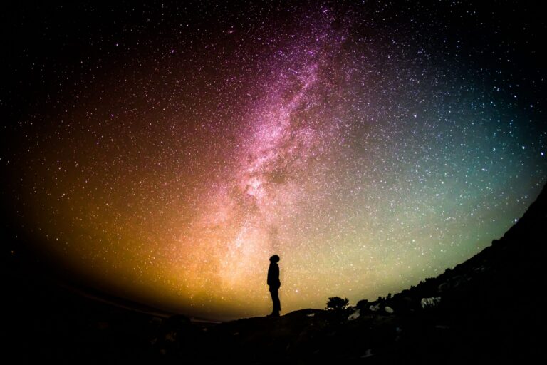 Person looking up at a star-filled night sky