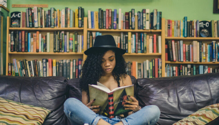 Young woman reading and studying to develop a lifelong learning habit