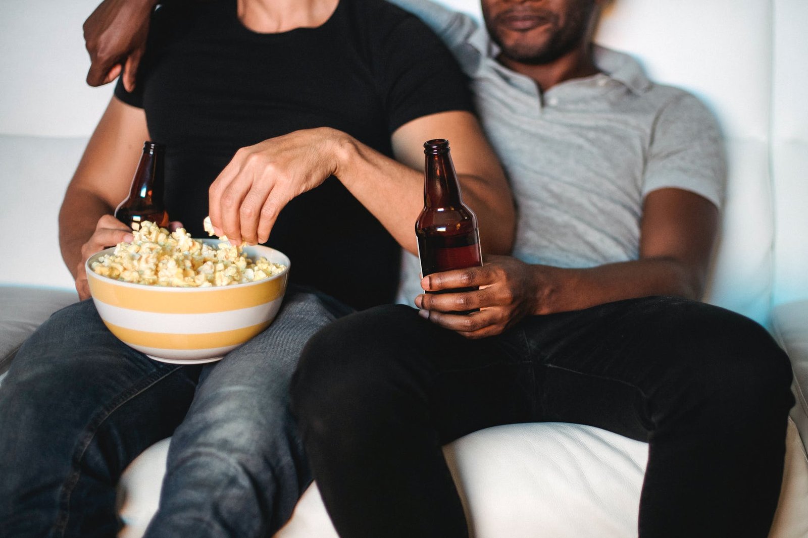 man and woman sitting on couch