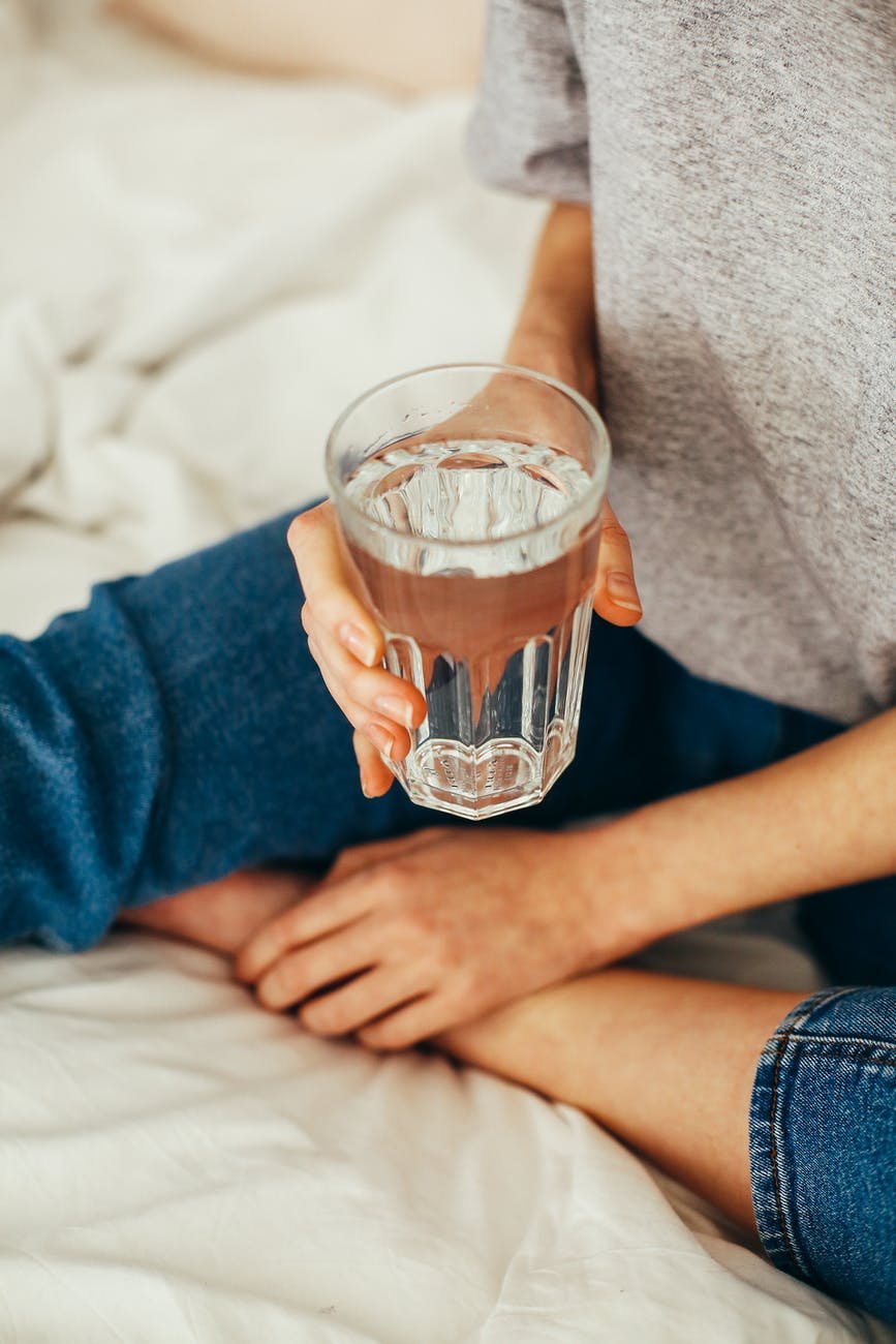 person holding drinking cup sitting